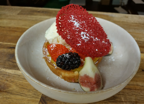 Parisian Flan Custard with seasonal berries, fig and red sugar decoration