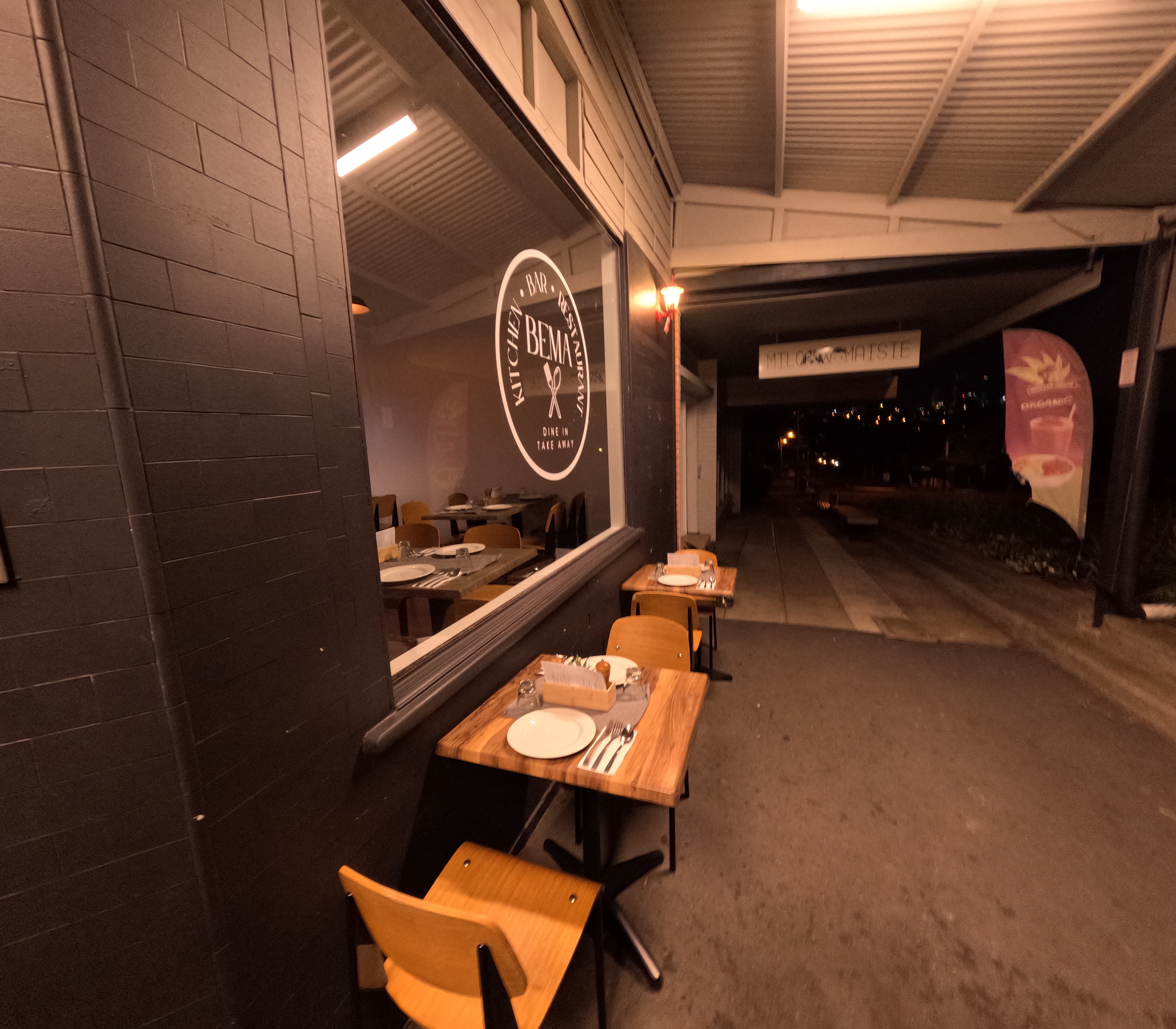 Bema Kitchen exterior at night with outdoor seating